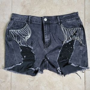 Black shorts with rips and rhinestone fringe